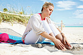 Young blond woman in casual wear on the beach