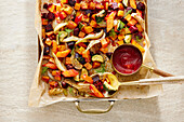 Colourful roast vegetables with tomato sauce