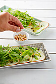 Kohlrabi and apple carpaccio with rocket, capers and pine nuts