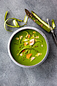 Asparagus and watercress soup with hot smoked salmon and black pepper