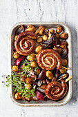 Cumberland sausage coils with potatoes, red onions, and garlic