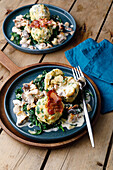 Cheese dumplings with mushroom-bacon sauce and spinach