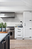 White kitchen cabinets with white subway tiled backsplash