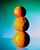 Citrus fruits (blood orange, rangpur, orange), stacked on top of each other