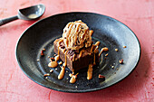 A chocolate brownie with salted caramel ice cream