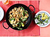 Tipsy Thai noodles with chicken in a wok