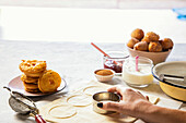 Doughnuts with a jelly filling being made