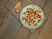 Penne with prawns, peppers and rocket