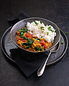 Vegan red lentil dal with tomatoes and spinach
