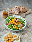 Pumpkin and bean salad with lamb's lettuce and goat's cheese au gratin