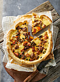 Autumn pumpkin quiche with minced meat and processed cheese