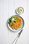 Spicy waffles with almonds, curd cheese, and avocado topping