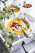 Carrot soup wit roasted bacon and cottage cheese