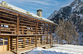 Restored Walser hut in a snow-covered landscape