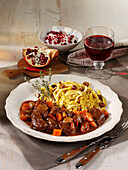 Game goulash with spaetzle and pomegranate cream