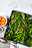 Warm green vegetable salad with spicy tomato dressing