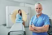 Radiologist and patient in CT scanning room