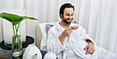 Man drinking tea at a spa