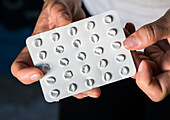 Woman holding an empty blister pack of pills