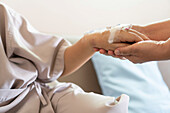 Holding hospital patient's hand