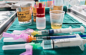 Syringes loaded with medication next to vials