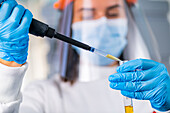 Researcher pipetting a sample