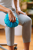Woman holding cold press to her knee