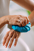 Woman holding ice bag compress on a painful wrist