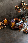 Carrot cake with chocolate icing and candied flowers