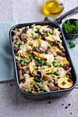 Vegan new potato bake with fried soy strips, mushrooms and peas