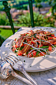 Duck salad with green beans on balcony table
