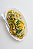 Spaghetti with fish ragout and summer squash