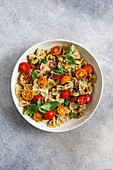 Colorful pasta salad with cherry tomatoes and broccoli pesto