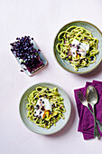 Pasta with wild garlic avocado pasta, poached eggs, and red cress