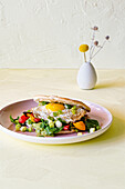 Green hummus pita with fried egg, grilled peppers and marinated spring onions