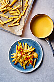 French fries with cheese sauce and mango tomato salsa