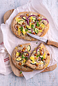 Wholemeal flatbreads with courgettes, chickpeas and onions baked with vegan cheese substitute