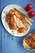Roasted chicken served with potato gratin with porcini mushrooms and shallots