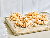 Fresh gluten-free pasta on wooden cutting board