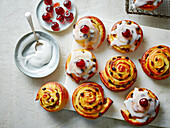 Belgian buns (yeast buns with golden raisins, fondant icing, and cherry topping)