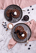 Vegan chocolate waffles with blueberry compote