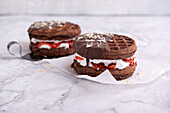 Vegan chocolate wafers with white chocolate cream, strawberry jam and plain icing