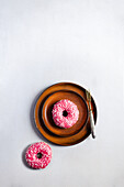Two donuts with pink icing