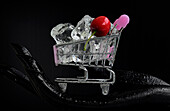 Mini shopping cart with ice cubes and a cherry