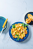 Harissa-Honig-Butter-Board mit Rosenknospen und Chiliflocken
