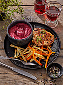 Pork steak with beet and sour cream dip with white and sweet potato fries