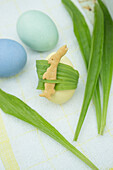 Bunny shaped cookies with ribwort on an Easter egg