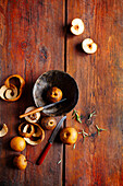 Nashi pears, partly peeled on wooden background