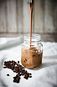 Coffee smoothie pouring into a jar