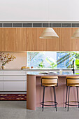 Open-plan kitchen with bar stools at island counter